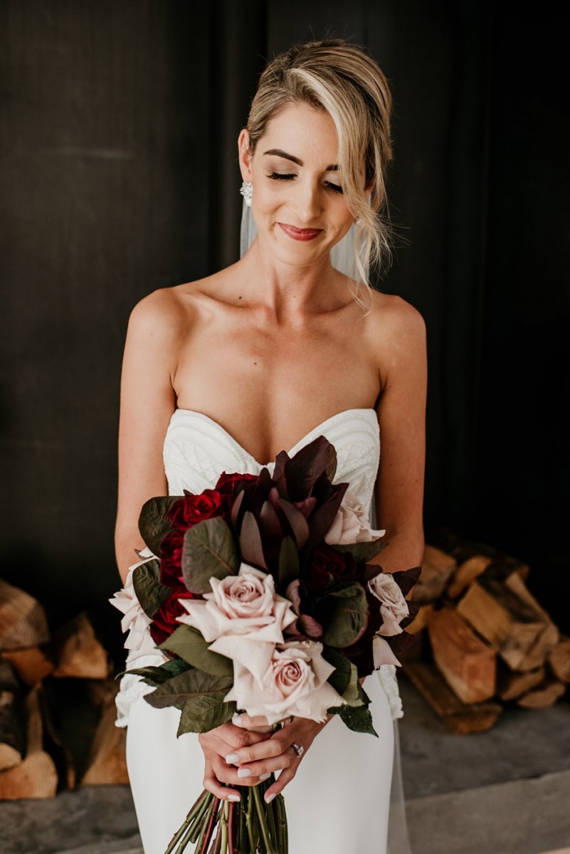Image of Cass in wedding dress with flowers